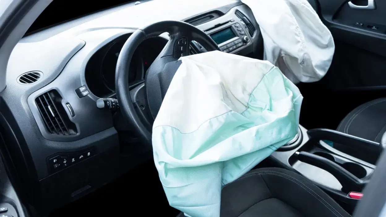 Interior de carro com airbags do condutor e passageiro dianteiro ativados após colisão